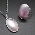 Close-up detail view of natural pink oval sea shell pendant necklace and ring set - Necklace Pendant and Ring Set / Pink-Silver