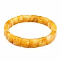 Detailed macro view of a natural yellow crystal bracelet with square faceted beads - Citrine