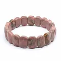 Faceted natural rhodonite stone bracelet featuring distinctive pink and black marble patterns - Rhodonite
