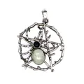 Detailed close-up view of vintage silver spider web pendant with natural green stone - Labradorite