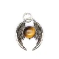 Close-up detail of vintage silver angel wings pendant featuring a round tiger eye stone - Tiger's Eye