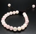 Detailed view of 8mm natural pink rose quartz stone beads on a handmade braided bracelet - Rose Quartz