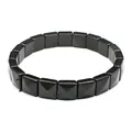Close-up of black square faceted natural stone bracelet with pyramid texture details - Obsidian