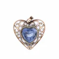 Macro view of a vintage heart-shaped pendant with blue natural stone inlay - Blue Sodalite