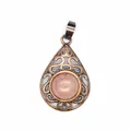 Detail shot of natural red aventurine teardrop pendant with vintage bronze openwork. - Rhodonite