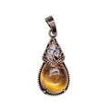 Macro detail view of retro teardrop pendant featuring a natural tiger's eye stone - Tiger's Eye