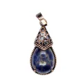 Detail view of a vintage bronze water drop pendant with dark blue natural stone - Sodalite