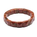 Close-up of faceted square red natural stone beads on an elastic bracelet for jewelry - Marble Red Stone