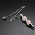 Detailed view of rose quartz dowsing pendulum with silver chain on black surface - Pendulum Pendant (Rose Quartz) / Rose Quartz