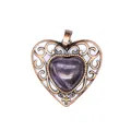 Detailed view of a vintage bronze heart pendant with a purple amethyst-like stone center. - Amethyst
