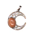 Detailed macro view of antique filigree crescent moon pendant with goldstone inlay - Gold Sandstone