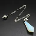Detailed macro view of a faceted opal gemstone pendulum with a silver chain link - Opal