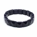 Detailed macro view of a blue goldstone bracelet with faceted square pyramid beads - Blue Sandstone