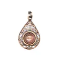 Detailed view of teardrop pendant with red aventurine stone and antique hollow metalwork - Watermelon red