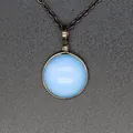 Close-up of light blue round stone pendant with vintage wire-wrapped detail - Opal