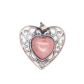Close-up view of a vintage hollow heart-shaped pendant featuring a natural pink stone inlay - Watermelon red