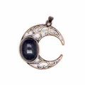 Macro view of antique bronze crescent moon pendant with blue goldstone cabochon - Blue Sandstone