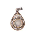 Detail view of a vintage bronze hollow teardrop pendant with a natural stone - White Crystal