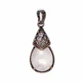 Detailed macro view showing the texture of teardrop rose quartz pendant with copper - Rose Quartz