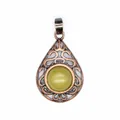 Vintage hollow teardrop pendant with central greenish-yellow gemstone in copper finish. - Topaz