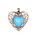 Close-up detail of a vintage bronze openwork heart pendant with blue turquoise stone - Blue Turquoise