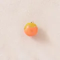 Detailed macro view of a 3D persimmon fruit pendant for DIY jewelry and crafts. - Persimmon