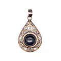Close-up detail of a vintage teardrop pendant with blue sandstone and antique copper filigree - Blue Sandstone
