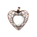 Vintage bronze hollow filigree heart pendant with white natural stone inlay detail view - Howlite