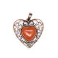 Detailed view of vintage bronze hollow heart pendant with red natural stone inlay - Red Jasper