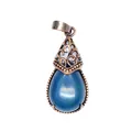 Close-up detail of a vintage teardrop pendant featuring a blue natural stone and filigree - Blue Agate