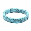 Detailed close-up of square turquoise stone beads featuring natural black marble veining - Turquoise