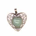 Detailed macro view of vintage hollow heart pendant with green natural stone inlay - Aventurine Jade