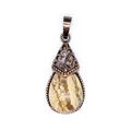 Close-up view of a vintage water-drop natural stone pendant with bronze filigree detail - Jasper