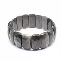 Macro detail showing faceted texture of dark grey natural stone stretch bracelet - Silver Sheen Obsidian
