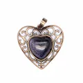 Detailed macro view of a vintage bronze hollow heart pendant with blue sandstone. - Blue Sandstone