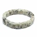 Detailed macro shot of natural dalmatian jasper stones on a faceted square bead bracelet - Sky Blue