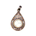 Detailed view of vintage hollow teardrop pendant with a white turquoise stone inlay - Howlite
