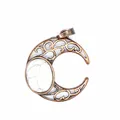 Detailed macro shot of an antique crescent moon pendant with white marble stone. - Howlite