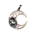 Close-up of antique hollow moon pendant with snowflake obsidian stone inlay - Snowflake Obsidian