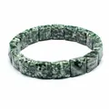 Close-up of a natural green and white marbled stone square faceted bead bracelet - Green Spotted Stone