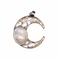 Detail view of antique moon pendant with hollow filigree and natural crystal stone inlay. - White Crystal