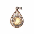 Macro detail of vintage style teardrop pendant with filigree design and natural stone inset - Jasper