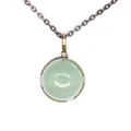 Close-up detail of a vintage bronze necklace featuring a green round natural stone pendant - Aventurine Jade