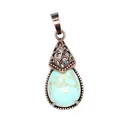 Detailed macro view of vintage bronze teardrop pendant featuring turquoise-patterned stone - Turquoise