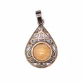 Detailed view of vintage hollow teardrop pendant with central natural red aventurine stone. - Red Aventurine