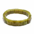 Detail showing olive green faceted natural stone square bead bracelet with polished finish - Olive Jade