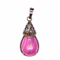Close-up of teardrop-shaped pink agate pendant with vintage filigree metal cap. - Pink Agate