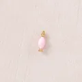 Close-up detail view of a pink candy shaped pendant with a polished gold finish - Pink Candy