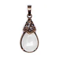 Macro view of vintage teardrop pendant with milky white stone and antique copper filigree - White Crystal