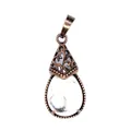 Detailed view of retro waterdrop pendant with white marbled stone and copper filigree. - Howlite